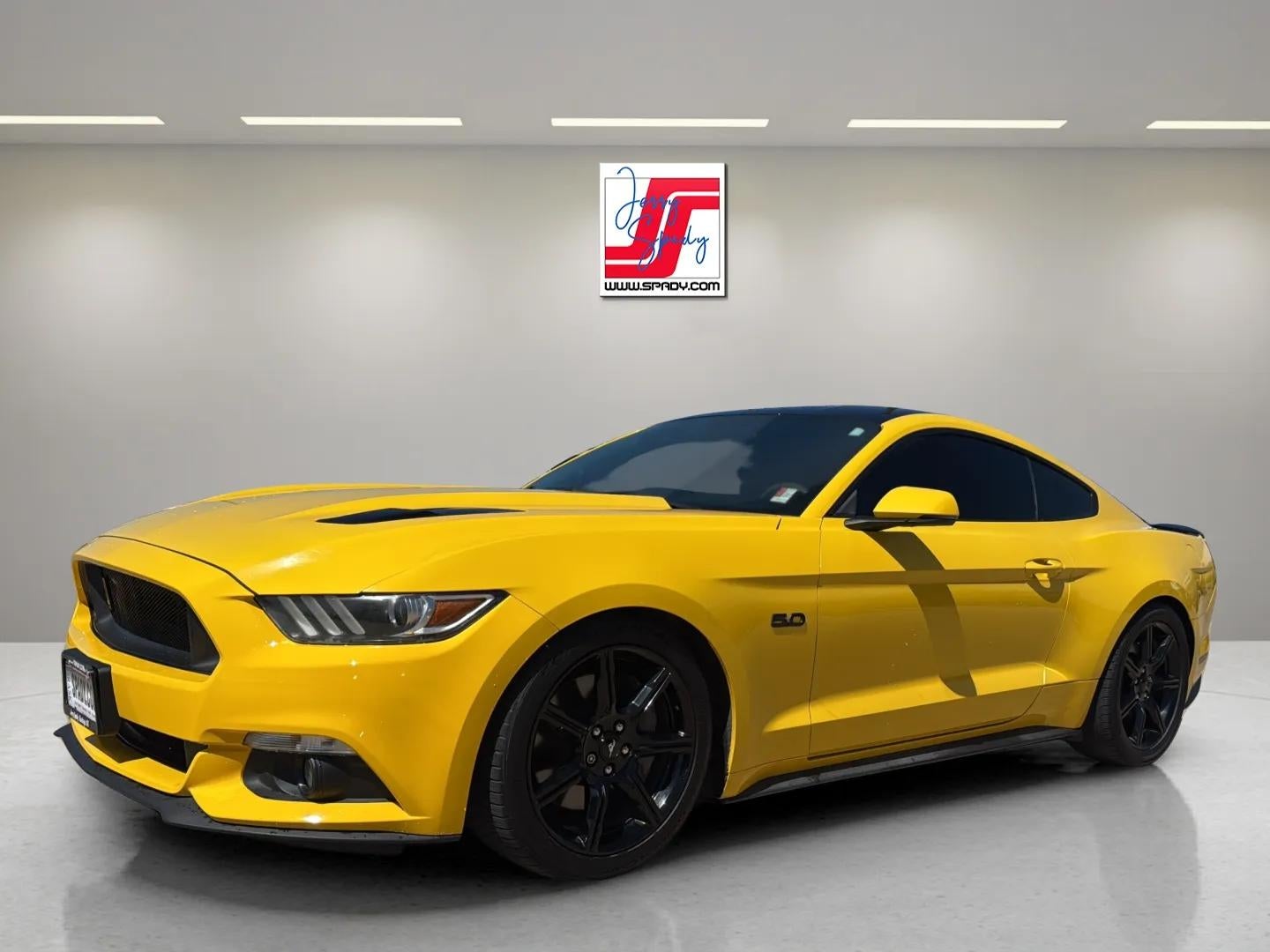 2015 Ford Mustang GT in Yellow — front three-quarter view