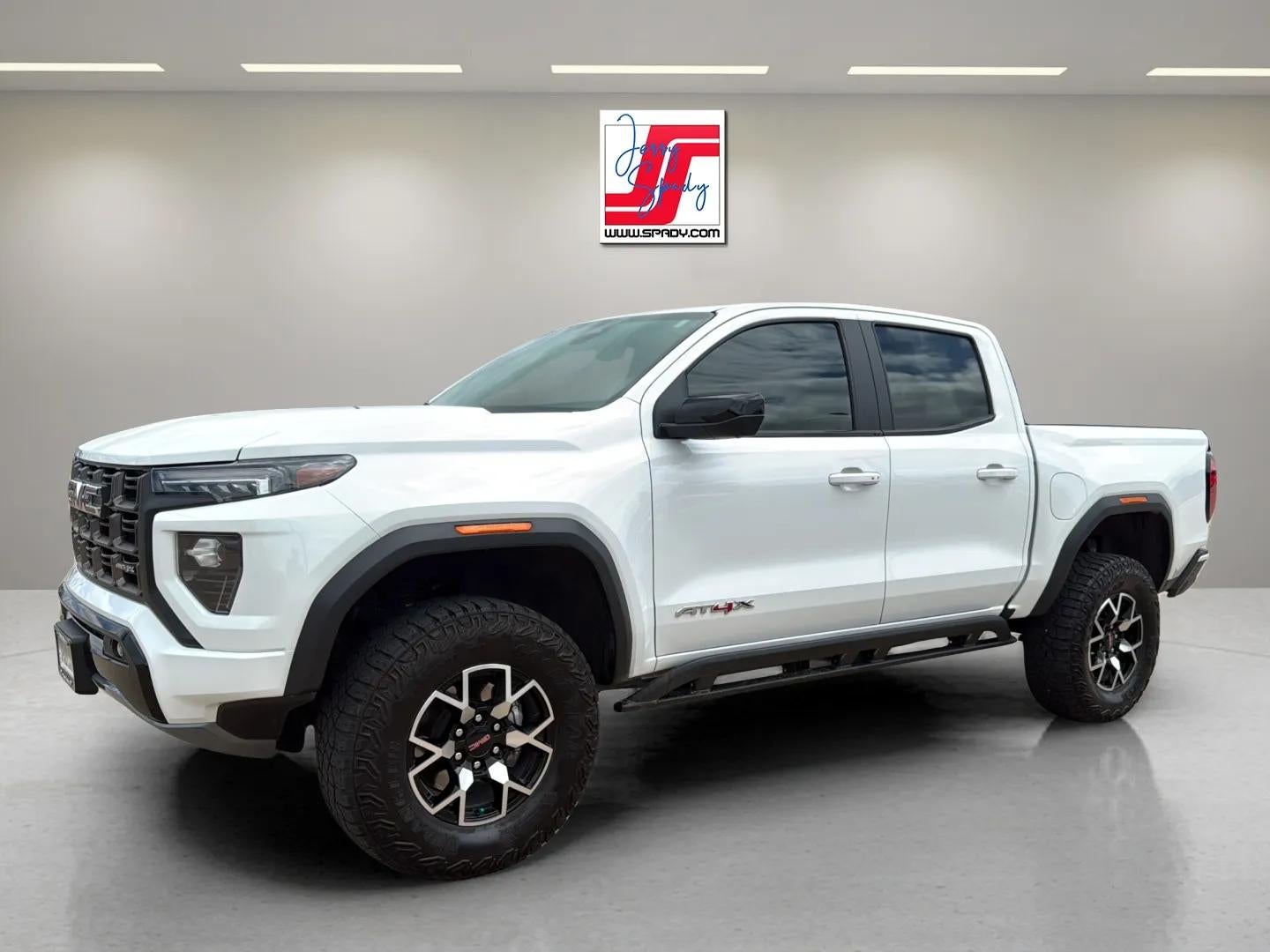 2024 GMC Canyon AT4X in Summit White — front three-quarter view